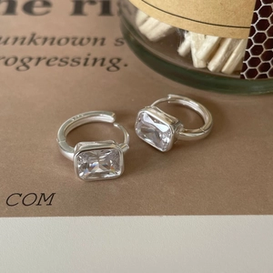 Macro view of 925 sterling silver hoop earrings with rectangular cubic zirconia stones