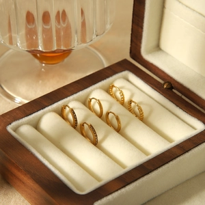 Three pairs of 18k gold plated stainless steel hoop earrings in a wooden jewelry box
