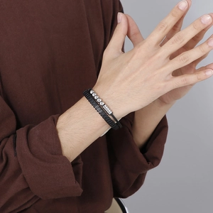 Close-up of men's punk style double-layered leather and silver bead bracelet on wrist