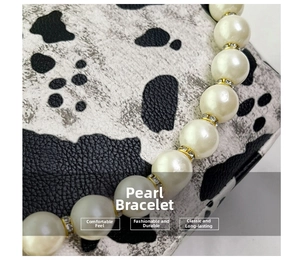 Close-up of white pearl bracelet with gold metal spacers and sparkling rhinestone details