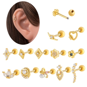 Macro detail of 14K gold cartilage studs with zircon flowers, hearts and pearls