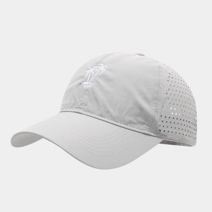 Close-up of laser-cut ventilation holes and white palm tree embroidery on light gray cap