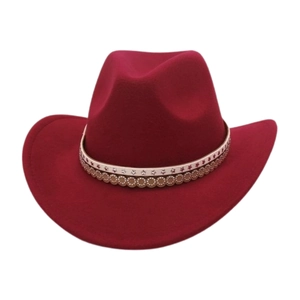 Detail of burgundy felt cowboy hat featuring star patterned band and metal studs decoration