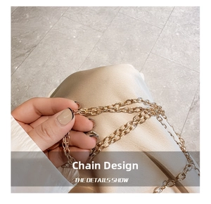 Close-up of a premium gold-toned metal chain strap on a designer acrylic heart bag