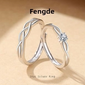 Macro view of S925 sterling silver couple rings with Mobius weave and small zircon