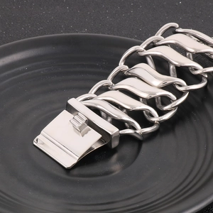 Macro view of wide silver titanium steel bracelet with twisted links and folding clasp