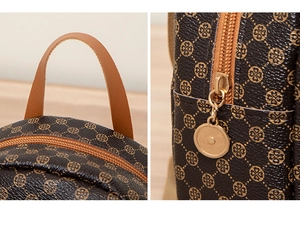 Detailed macro view of dark brown PU leather backpack with geometric pattern and gold zipper