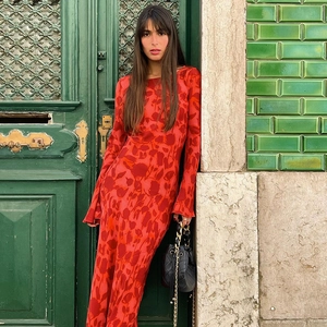 Detail of red long-sleeve maxi dress featuring abstract floral prints and slim-fit cut