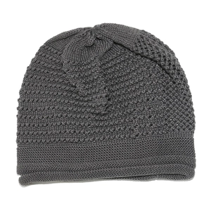 Close-up of dark grey knitted winter beanie featuring wavy weave patterns and a rolled hem