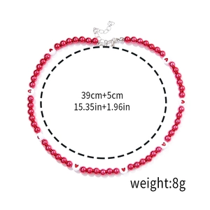 Macro detail of red and white beaded Christmas necklace with length 39cm+5cm and 8g weight