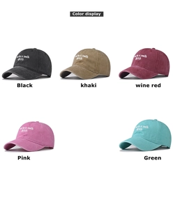 Color display of washed vintage baseball caps with embroidered text in multiple shades