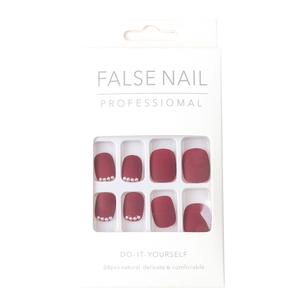 Short round matte burgundy press-on nails set with elegant white pearl accents in box