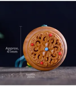 Macro detail of hand-carved sandalwood sachet pendant with 41mm diameter dimensions