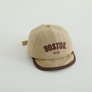 Detail of embroidered BOSTON text and 1630 on the khaki cotton baby baseball cap