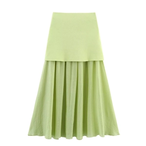 Detail of light green pleated skirt with high-quality stitching and fabric texture