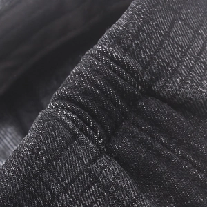 Close-up detail of the elastic pleated texture on vintage denim newsboy cap fabric