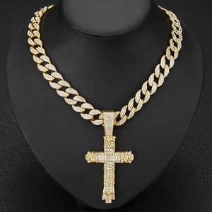 Detail of gold Cuban chain necklace with sparkling iced-out cross pendant on black bust