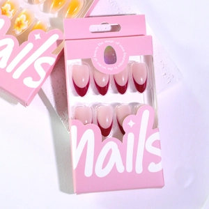 French burgundy almond press-on nails with deep red tips in elegant pink retail packaging