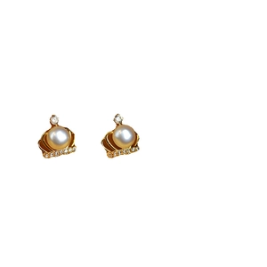 Elegant gold crown stud earrings featuring white pearls and shimmering cubic zirconia stones