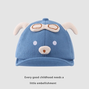 Detail of blue knit baby cap with animal face, 3D ears and cute glasses decor