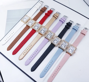 Close-up of square rhinestone watch dials with Roman numerals and colorful straps