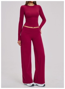 Close-up of deep burgundy yoga set featuring slim-fit long sleeve top and wide-leg pants