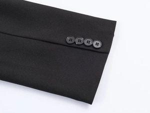 Detail of black blazer cuffs featuring four neatly arranged buttons on high-density fabric
