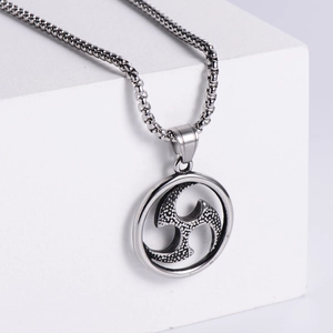 Retro stainless steel necklace featuring a Tomoe symbol pendant on a white geometric block