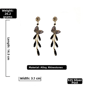 Macro shot of butterfly tassel earrings with black teardrop crystals and silver needles