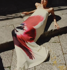 Outdoor shot of contrast color tube maxi dress featuring red and black abstract art print
