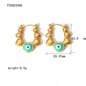 Detail of 18K gold-plated heart U-shaped earrings with evil eye turquoise charms