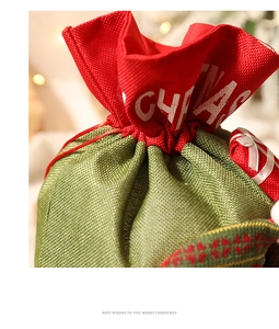 Close-up of red and green linen Christmas gift bag with drawstrings and burlap texture
