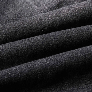 Macro shot of dark grey denim fabric texture showing soft weave and material thickness