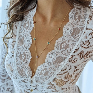 Long Y-shaped gold necklace with multi-colored heart zircon pendants on a model