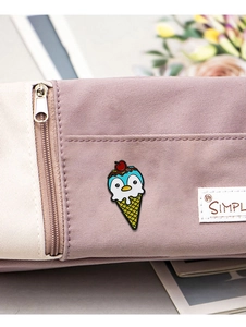 Cute penguin ice cream enamel pin badge decorated on a beige and pink pencil case