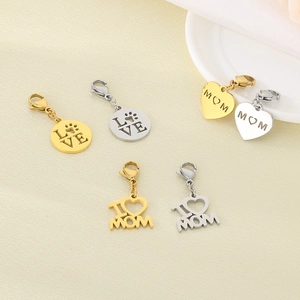 Detailed view of hollow MOM heart pendants and LOVE charms in gold and silver finishes