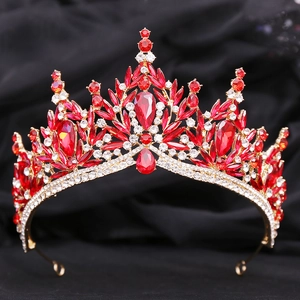Detailed close-up of a bridal tiara featuring red crystals and sparkling rhinestones