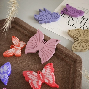 Detailed close-up of colorful butterfly silicone molds for DIY keychain pendant making