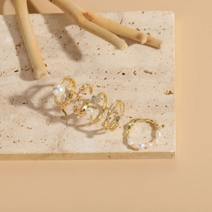 Macro shot of 14K gold plated rings with freshwater pearls and sparkling zircons set