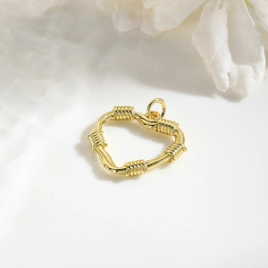 Detailed view of a gold plated hollow heart pendant for DIY jewelry making and necklaces
