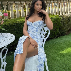 Detail of blue floral dress featuring delicate lace trim and a stylish side slit design