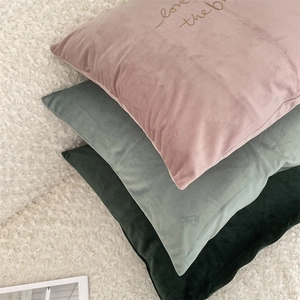 Detail of Morandi velvet cushion covers with elegant gold letter embroidery