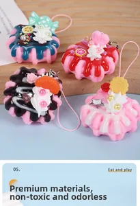 Detailed view of four miniature dessert keychains with cream and love heart charms