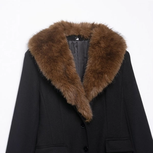 Women's black wool coat featuring a stylish brown faux fur collar and button closure