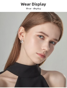 Close-up of elegant moissanite silver earrings with layered hollow lines on female model