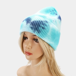 Detail of blue and white tie-dye knit beanie showing ribbed texture and cuffed hem