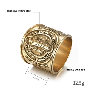 Macro view of gold St. Benedict medal ring in fine steel with detailed religious engraving