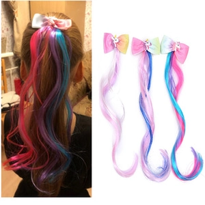 Detailed view of girls' rainbow wig hair clips with cute unicorn bows in three colors