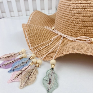 Summer straw sun hat for women featuring wavy brim and colorful embroidered feather charms
