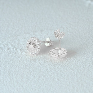 Close-up of S925 sterling silver stud earrings with sparkling cubic zirconia pavé